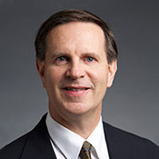 An image of Doctor Scott Strelow in front of a gray background.